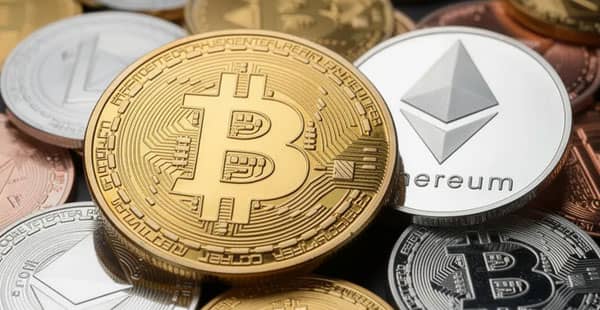 The image displays a collection of various cryptocurrency coins, prominently featuring Bitcoin and Ethereum, along with several altcoins. This vibrant assortment represents the diverse world of crypto, which is increasingly integrated into online casinos and gaming platforms.