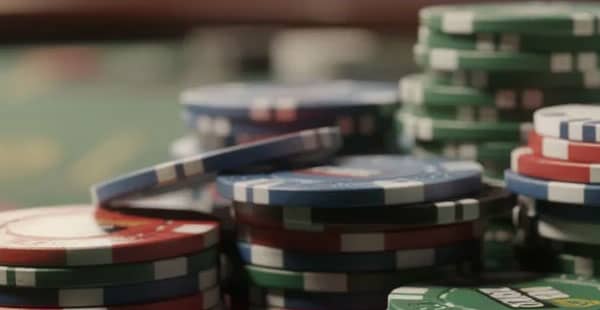 The image features a vibrant pile of colorful casino chips, showcasing a variety of hues that represent the excitement of online casinos. These chips symbolize the potential for players to win real money while enjoying popular casino games and taking advantage of various deposit bonuses and promotions.